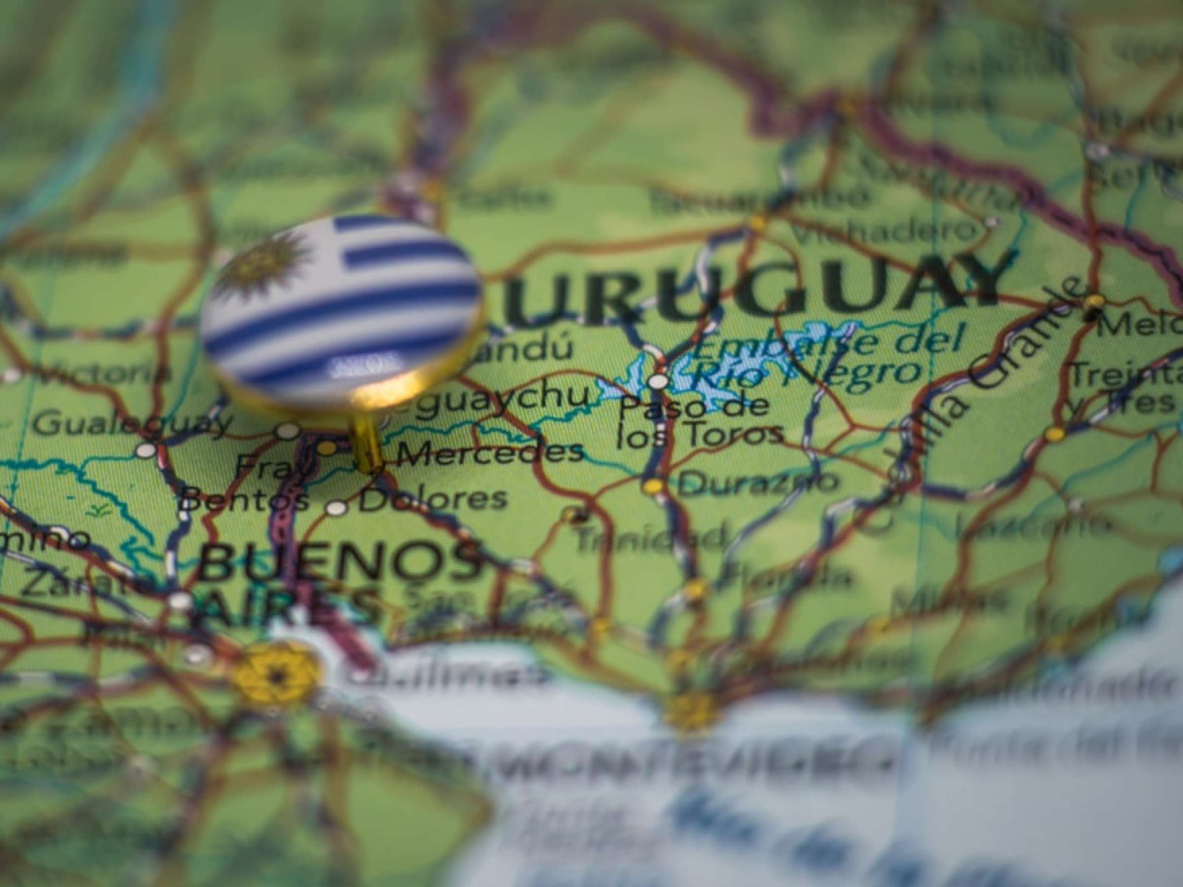 A pin with the flag of Uruguay pinned on a map.